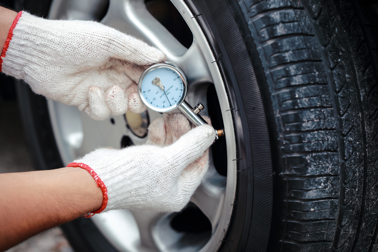 Checking-Tire-Pressure-During-Flat-Tire-Service-Call Checking-Tire-Pressure-During-Flat-Tire-Service-Call